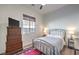 Cozy bedroom with a ceiling fan, dresser with TV and window for natural light at 56 Tatahatso Point St, Henderson, NV 89011