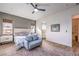 Bright bedroom featuring a sitting area, a plush bed, and easy access to the bathroom at 56 Tatahatso Point St, Henderson, NV 89011