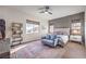 Cozy bedroom with a stylish area rug, comfortable seating, and a decorative bookshelf at 56 Tatahatso Point St, Henderson, NV 89011