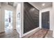 Contemporary home entryway showcasing a modern accent wall, wood-look tile flooring, and neutral paint at 56 Tatahatso Point St, Henderson, NV 89011