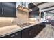 Modern kitchen boasts sleek black cabinets, stainless steel appliances, and a light tiled backsplash at 56 Tatahatso Point St, Henderson, NV 89011