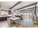 Open-concept living and dining area with neutral walls and wood-look tile floors at 56 Tatahatso Point St, Henderson, NV 89011
