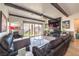 Inviting living room featuring a fireplace, sleek TV, comfortable seating, and seamless indoor-outdoor flow at 56 Tatahatso Point St, Henderson, NV 89011