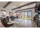 Relaxing living room with a cozy fireplace, comfortable leather seating, and sliding glass doors to the outdoor patio at 56 Tatahatso Point St, Henderson, NV 89011