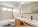 Bright bathroom featuring double sinks, wood cabinets, tub, and modern fixtures at 5629 Caladonia Ave, Las Vegas, NV 89110