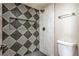 Modern bathroom featuring stylish tile work, a built-in shelf, and sleek fixtures at 5629 Caladonia Ave, Las Vegas, NV 89110