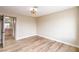 Inviting bedroom featuring hardwood floors and light neutral walls leading to ensuite bathroom at 5629 Caladonia Ave, Las Vegas, NV 89110