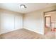 Bright bedroom featuring neutral walls, carpet flooring, closet with sliding doors, and view to hallway at 5629 Caladonia Ave, Las Vegas, NV 89110