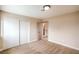 Bedroom featuring carpeted floors, a closet, and neutral walls, with a view of the upstairs hallway at 5629 Caladonia Ave, Las Vegas, NV 89110