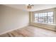 Bright bedroom showcasing hardwood floors, a large window with backyard views and neutral walls at 5629 Caladonia Ave, Las Vegas, NV 89110