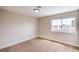 Cozy bedroom featuring carpeted floors, neutral walls, and a bright window with backyard views at 5629 Caladonia Ave, Las Vegas, NV 89110