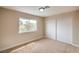 Bright bedroom featuring neutral walls, carpet flooring, window for natural light and closet with sliding doors at 5629 Caladonia Ave, Las Vegas, NV 89110