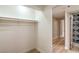 Spacious walk-in closet with shelving and hardwood floors next to a stylish bathroom at 5629 Caladonia Ave, Las Vegas, NV 89110