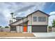 Charming two-story home with a well-maintained yard and a bright orange front door at 5629 Caladonia Ave, Las Vegas, NV 89110