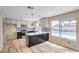 Modern kitchen features stainless steel appliances, an island with a breakfast bar, and a view of the pool at 5629 Caladonia Ave, Las Vegas, NV 89110