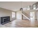 Bright living room with modern decor, high ceilings, a cozy fireplace, and staircase to the upper level at 5629 Caladonia Ave, Las Vegas, NV 89110