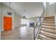 Spacious living room with modern lighting, a fireplace, and a staircase leading to the second floor at 5629 Caladonia Ave, Las Vegas, NV 89110
