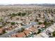 Expansive aerial view showcases a thriving residential neighborhood with community pools and lush landscaping at 619 Ancient Mayan Dr, Henderson, NV 89015