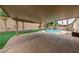 Large covered patio overlooks a private backyard with a pool and mature landscaping at 619 Ancient Mayan Dr, Henderson, NV 89015