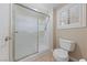 Bathroom with a walk-in shower, a toilet, and a window with shutters for natural light at 619 Ancient Mayan Dr, Henderson, NV 89015
