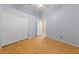 Bright bedroom features wood floors, neutral walls, ceiling fan, and large closet at 619 Ancient Mayan Dr, Henderson, NV 89015