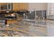 Close-up of stunning granite countertops in the kitchen with stainless steel sink and modern faucet at 619 Ancient Mayan Dr, Henderson, NV 89015