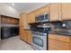 Bright kitchen boasts stainless steel appliances, granite counters, and ample wood cabinetry at 619 Ancient Mayan Dr, Henderson, NV 89015