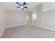 Open-concept living room featuring neutral walls, tiled floors, ceiling fan and plenty of space for entertaining at 619 Ancient Mayan Dr, Henderson, NV 89015