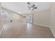 Bright and airy living room with tile flooring, ceiling fan, and French doors to a patio, creating a seamless indoor-outdoor flow at 619 Ancient Mayan Dr, Henderson, NV 89015
