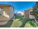Landscaped backyard offers low-maintenance artificial grass, a shed, and space for activities at 6225 Sadler Dr, Las Vegas, NV 89130