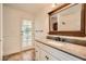 Charming bathroom with granite counters, decorative mirror and access to outdoor space at 6225 Sadler Dr, Las Vegas, NV 89130
