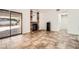 Cozy living room with tile flooring, fireplace, and sliding door access to outdoor space at 6225 Sadler Dr, Las Vegas, NV 89130