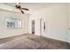 Spacious main bedroom boasts carpeted flooring, ceiling fan, and ensuite bathroom at 6225 Sadler Dr, Las Vegas, NV 89130