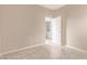 Bedroom with neutral walls and tiled floor, looking out to the laundry room area at 6365 Diego Dr, Las Vegas, NV 89156