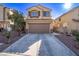Inviting two-story home with a long driveway and desert landscaping in a well-kept neighborhood at 6365 Diego Dr, Las Vegas, NV 89156