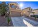 Attractive two-story home with a two-car garage, desert landscaping, and a spacious driveway at 6365 Diego Dr, Las Vegas, NV 89156
