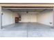 Spacious two-car garage with an open door, concrete flooring, and an armoire at 6365 Diego Dr, Las Vegas, NV 89156