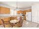 Bright kitchen featuring light wood cabinets, white appliances, and tiled flooring at 6365 Diego Dr, Las Vegas, NV 89156