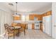 Cozy kitchen features wooden cabinets, white appliances, and a casual dining area at 6365 Diego Dr, Las Vegas, NV 89156
