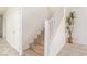 Wooden staircase with white railing and a potted plant adds a touch of nature at 6365 Diego Dr, Las Vegas, NV 89156