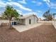 View of the backyard with a patio, rock ground cover, and block fence at 6412 Dallaswood Ln, Las Vegas, NV 89156