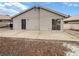 Large backyard showcasing an outdoor patio, neutral stucco, and low maintenance landscaping at 6412 Dallaswood Ln, Las Vegas, NV 89156