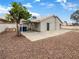 A backyard with a concrete patio, rock ground cover, and block fence at 6412 Dallaswood Ln, Las Vegas, NV 89156