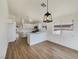 Charming kitchen featuring white cabinets, a breakfast bar, and modern appliances at 6412 Dallaswood Ln, Las Vegas, NV 89156