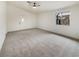 Expansive living room with large windows, neutral carpeting, and abundant natural light at 6412 Dallaswood Ln, Las Vegas, NV 89156