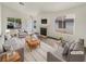 Bright living room featuring neutral decor, hardwood flooring, fireplace, and large windows at 6412 Dallaswood Ln, Las Vegas, NV 89156