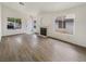 Bright living room featuring neutral decor, hardwood flooring, fireplace, and large windows at 6412 Dallaswood Ln, Las Vegas, NV 89156