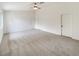 Open living room with neutral carpeting, multiple doors, and ample space for furniture at 6412 Dallaswood Ln, Las Vegas, NV 89156