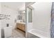 Bright bathroom featuring tiled floors, a white vanity, and a shower-tub combination at 680 Cervantes Dr, Henderson, NV 89014