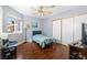 Comfortable bedroom featuring hardwood floors, a ceiling fan, and lots of natural light at 680 Cervantes Dr, Henderson, NV 89014